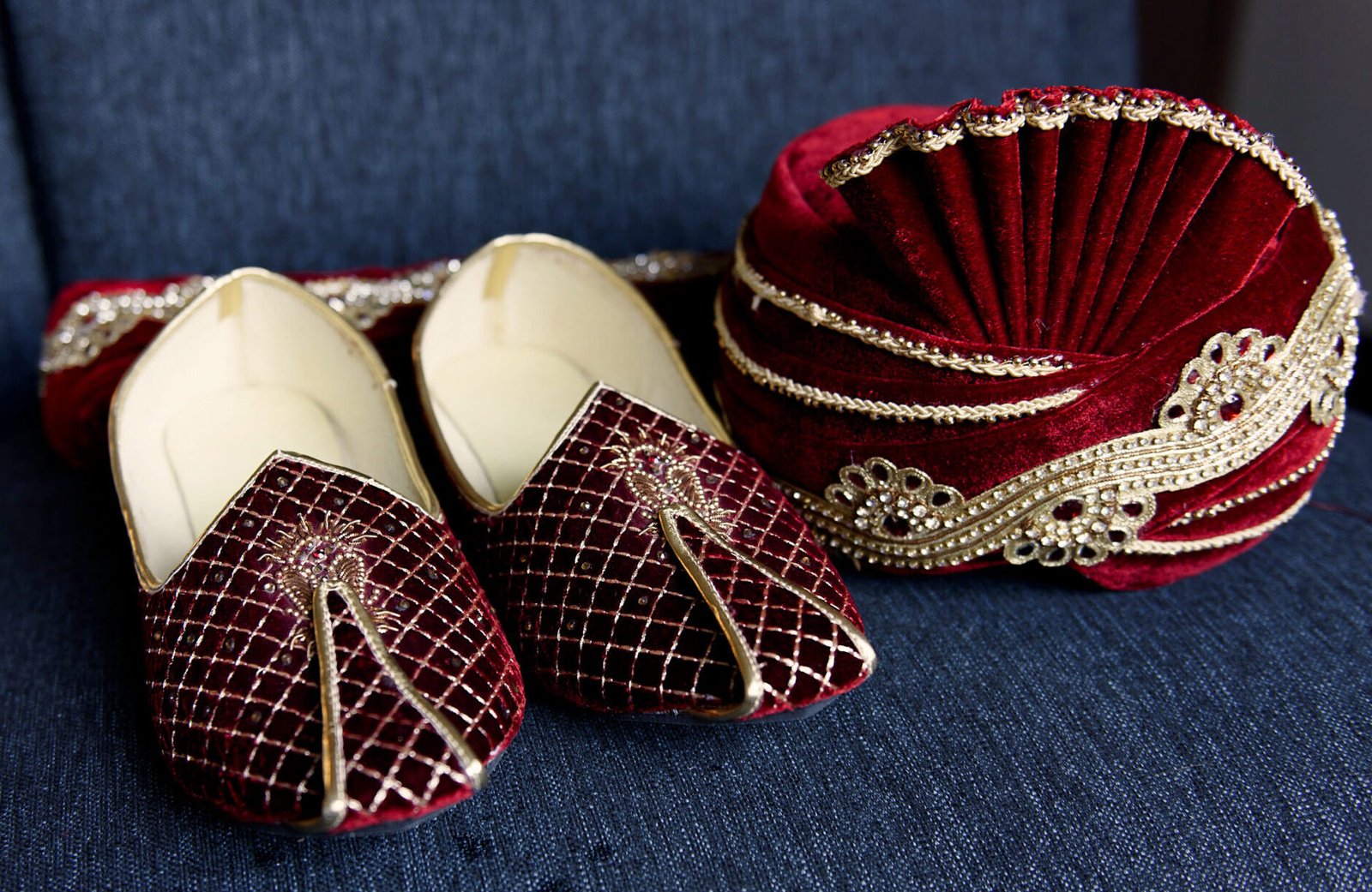 Red Indian's groom shoes and hat lie on the blue chair
